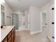 Well-lit bathroom features a single sink vanity with a tub-shower combo and tile floors at 14700 Old Vermillion Dr, Huntersville, NC 28078