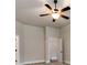 Cozy bedroom featuring a ceiling fan, neutral paint, and inviting doorway at 14700 Old Vermillion Dr, Huntersville, NC 28078