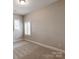 A simple room with carpet and two windows at 14700 Old Vermillion Dr, Huntersville, NC 28078