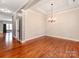 Spacious dining area with hardwood floors, elegant chandelier, and neutral wall paint, creating a welcoming atmosphere at 14700 Old Vermillion Dr, Huntersville, NC 28078