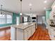 Modern kitchen boasts a large center island with granite countertops, white cabinetry, and open layout into living spaces at 14700 Old Vermillion Dr, Huntersville, NC 28078