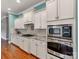 Gourmet kitchen features white cabinetry, granite countertops, and stainless steel appliances at 14700 Old Vermillion Dr, Huntersville, NC 28078
