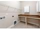 Spacious laundry room equipped with ample counter space, overhead storage, and utility connections at 14700 Old Vermillion Dr, Huntersville, NC 28078
