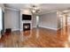 Inviting living room features a cozy fireplace, hardwood floors, neutral walls, and seamlessly connects to other areas at 14700 Old Vermillion Dr, Huntersville, NC 28078