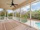 A screened porch with a ceiling fan provides a relaxing view of the backyard and pool at 14700 Old Vermillion Dr, Huntersville, NC 28078