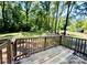 A wooden back deck with a view to a wooded backyard at 1583 Green Circle Dr, Gastonia, NC 28054
