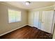 Bedroom featuring wood flooring, neutral paint, and a window and closet at 1583 Green Circle Dr, Gastonia, NC 28054