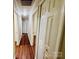 Hallway featuring wood flooring, neutral paint, and doors on either side at 1583 Green Circle Dr, Gastonia, NC 28054