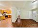 Open-concept living room flows into the kitchen, featuring wood flooring and neutral paint at 1583 Green Circle Dr, Gastonia, NC 28054