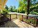 Inviting wooden porch with railing, perfect for enjoying the peaceful neighborhood views at 1583 Green Circle Dr, Gastonia, NC 28054