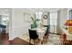Formal dining room with elegant table setting, chandelier, and wainscoting, ideal for gatherings at 16213 Kelby Cv, Charlotte, NC 28278