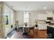 Bright dining room with hardwood floors, table and chairs, and door leading to the outside at 16213 Kelby Cv, Charlotte, NC 28278