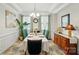 Formal dining room with wainscoting, designer rug, and buffet at 16213 Kelby Cv, Charlotte, NC 28278