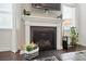 A fireplace is the central feature of a living space, with plants on either side at 16213 Kelby Cv, Charlotte, NC 28278