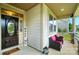 Cozy covered porch featuring comfy wicker chairs and charming decor elements for a relaxing atmosphere at 16213 Kelby Cv, Charlotte, NC 28278
