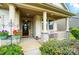 Inviting front porch with stone accents, columns, and beautiful landscaping for a warm welcome at 16213 Kelby Cv, Charlotte, NC 28278