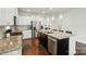 Eat-in kitchen features granite countertops, an island, and stainless steel appliances at 16213 Kelby Cv, Charlotte, NC 28278