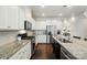 Kitchen with stainless steel appliances, granite counters, and dark wood floors at 16213 Kelby Cv, Charlotte, NC 28278