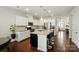 Eat-in kitchen features granite countertops, an island, and stainless steel appliances at 16213 Kelby Cv, Charlotte, NC 28278
