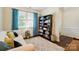 Comfortable living room with a bookshelf, cozy couch, and bright window with natural light at 16213 Kelby Cv, Charlotte, NC 28278