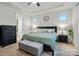 Comfortable main bedroom features a ceiling fan, tray ceiling, two windows and a bed with a green comforter at 16213 Kelby Cv, Charlotte, NC 28278