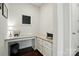 Cozy office nook with granite countertop, drawers, and overhead lighting at 16213 Kelby Cv, Charlotte, NC 28278