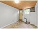Spacious unfinished basement with painted walls, utility hook ups, and a walkout door at 1713 Shamrock Dr, Charlotte, NC 28205