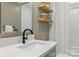 Stylish bathroom features a quartz countertop, modern faucet, and decorative shelving at 1713 Shamrock Dr, Charlotte, NC 28205