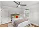 Cozy bedroom with neutral walls, hardwood floors, ceiling fan, and bright window at 1713 Shamrock Dr, Charlotte, NC 28205