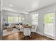 Cozy breakfast nook and living room with hardwood floors and plenty of natural light at 1713 Shamrock Dr, Charlotte, NC 28205