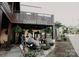 Summit Coffee shop exterior with patio seating and hanging ferns adds curb appeal at 1713 Shamrock Dr, Charlotte, NC 28205