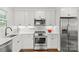 Modern kitchen with white cabinets, stainless steel appliances, and ample counter space for meal preparation at 1713 Shamrock Dr, Charlotte, NC 28205