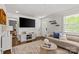 Bright and airy living room features hardwood floors, neutral decor, and modern furnishings at 1713 Shamrock Dr, Charlotte, NC 28205