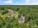 Aerial view of a neighborhood with a house and a lush tree canopy surrounding the homes at 1819 Brompton Ct, Newton, NC 28658