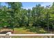 Green backyard surrounded by trees, viewed from a railed porch at 1819 Brompton Ct, Newton, NC 28658