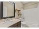 Bathroom vanity and shower with black framed mirror and floating wood shelves at 1819 Brompton Ct, Newton, NC 28658