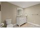 Bathroom featuring a modern vanity, mirror, toilet, and neutral wall paint at 1819 Brompton Ct, Newton, NC 28658