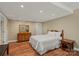 Well-lit bedroom with a neutral color scheme, hardwood floors, and simple furnishings at 1819 Brompton Ct, Newton, NC 28658