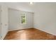 Bright bedroom with hardwood floors, a window, and a white closet door at 1819 Brompton Ct, Newton, NC 28658