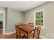 Dining room with hardwood floors, a square wooden table, and a window view at 1819 Brompton Ct, Newton, NC 28658