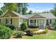Charming home featuring a covered front porch, manicured landscaping, and a well-maintained lawn at 1819 Brompton Ct, Newton, NC 28658