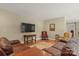 Comfortable living room with hardwood floors, leather sofas, chairs, and a flat screen TV at 1819 Brompton Ct, Newton, NC 28658