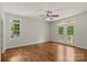 Bright living room with hardwood floors, ceiling fan, and access to a private balcony via glass paneled doors at 1819 Brompton Ct, Newton, NC 28658