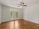 Bright living room with hardwood floors, ceiling fan, and access to a private balcony via glass doors at 1819 Brompton Ct, Newton, NC 28658