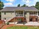 Back of house with a deck, brick foundation and stairs to the yard at 1819 Brompton Ct, Newton, NC 28658