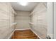 Spacious walk-in closet with hardwood floors and ample shelving for organizing clothes and accessories at 1819 Brompton Ct, Newton, NC 28658