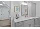 Stylish bathroom with grey vanity, modern fixtures, and decorative mirror at 20312 Deep Cove Ct, Cornelius, NC 28031