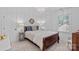 Charming bedroom with a decorative chandelier, a comfortable bed, and natural light at 20312 Deep Cove Ct, Cornelius, NC 28031