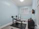 Bright exercise room with workout equipment, a wall-mounted TV, and a window providing natural light at 20312 Deep Cove Ct, Cornelius, NC 28031
