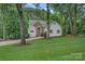 Charming home with stone accents, lush landscaping, and a well-manicured lawn at 20312 Deep Cove Ct, Cornelius, NC 28031